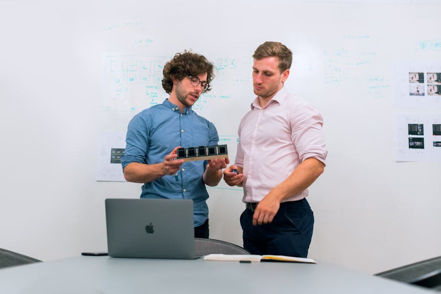 Engineers reviewing a technical prototype during a consultancy planning meeting